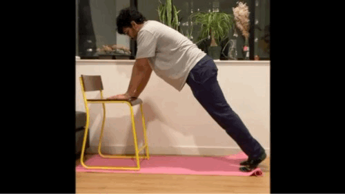 animation of a waist high push up done with hands on a chair