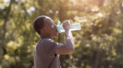 Man drinking water after exercising